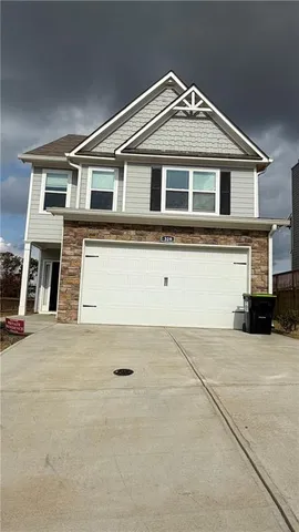 a front view of a house with a garage