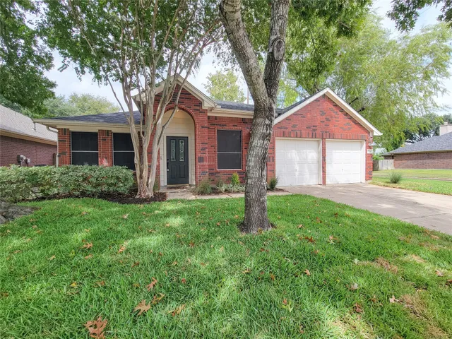 a house with green field in front of it