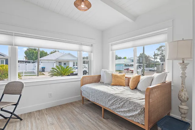 a large bed sitting in a bedroom next to a window