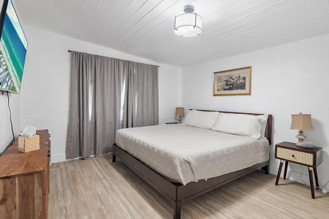 a view of a patio with table and chairs under an umbrella