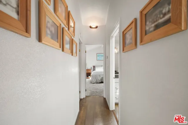 a bathroom with a granite countertop toilet a sink and a window