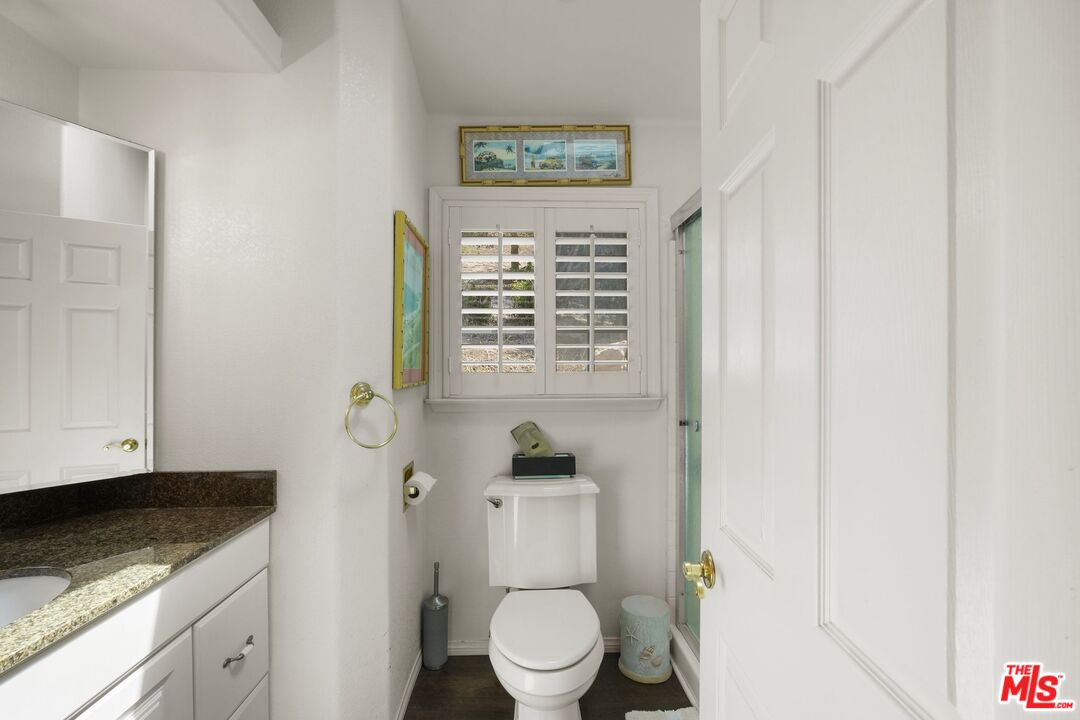 31 Paradise Cove Road Malibu, CA 90265 - Photo 18 of 27 a bathroom with a granite countertop toilet a sink and a window