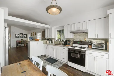 a kitchen with cabinets and steel stainless steel appliances