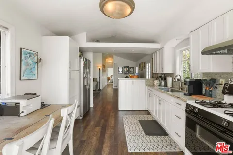 a kitchen with a sink appliances and cabinets