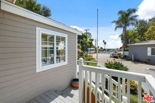 a view of a balcony with potted plants