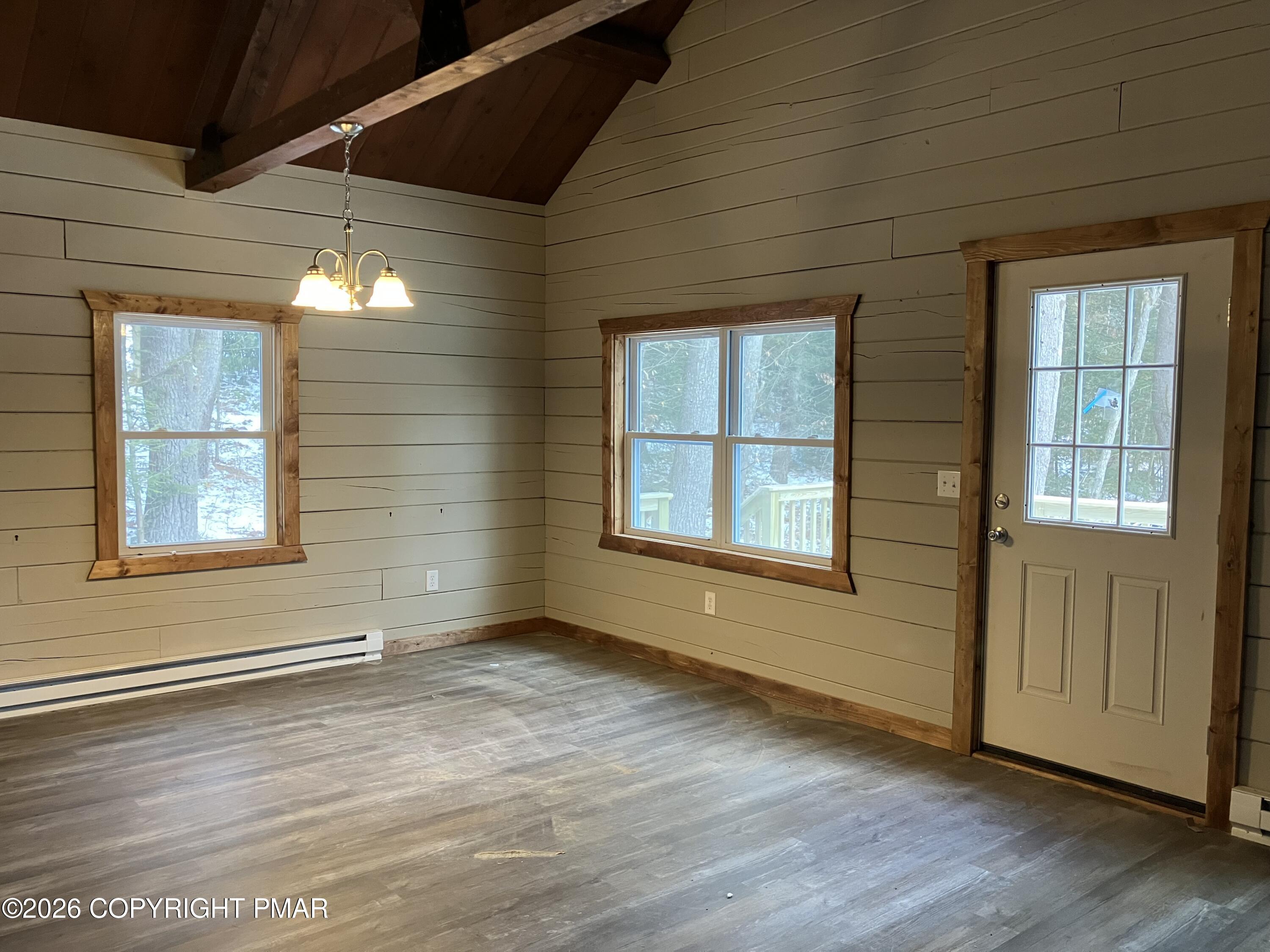 81 Henning Road Albrightsville, PA 18210 - Photo 4 of 9 an empty room with wooden floor and windows