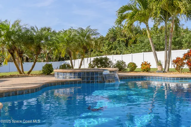 a living room with furniture a rug and white walls