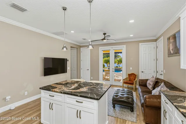 a bathroom with a granite countertop sink and a shower