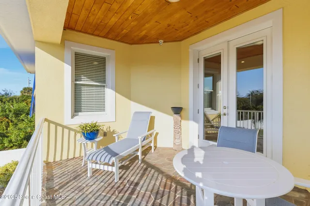 a kitchen with stainless steel appliances granite countertop a stove a refrigerator a kitchen island and chairs