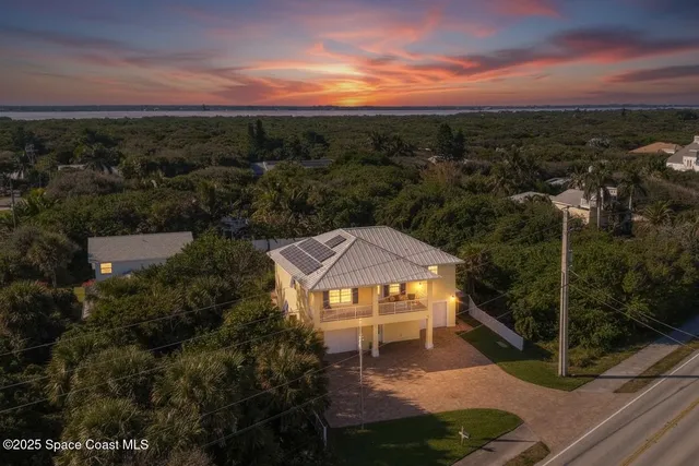a view of a house with swimming pool and sitting area