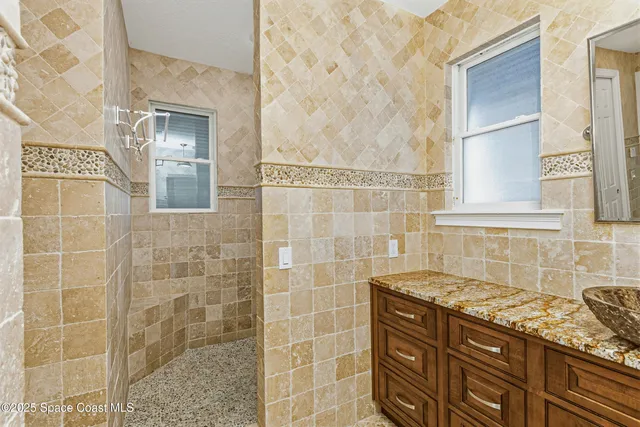 an aerial view of a house with a yard and lake view