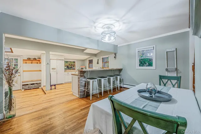a view of a dining room with furniture and wooden floor