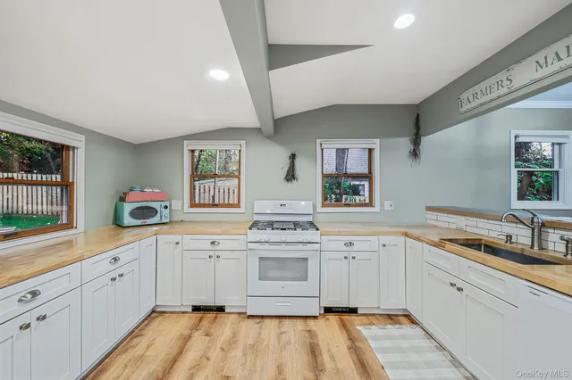 a kitchen with a sink stove and cabinets