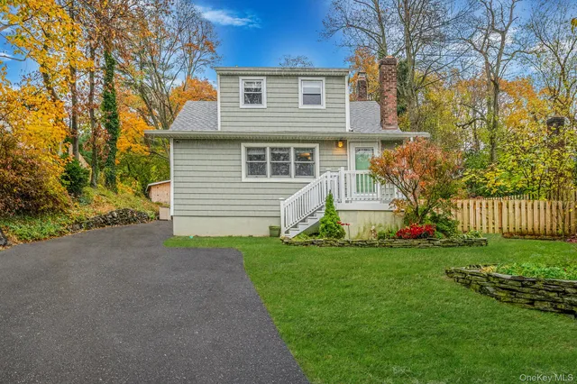 a front view of a house with a garden and yard
