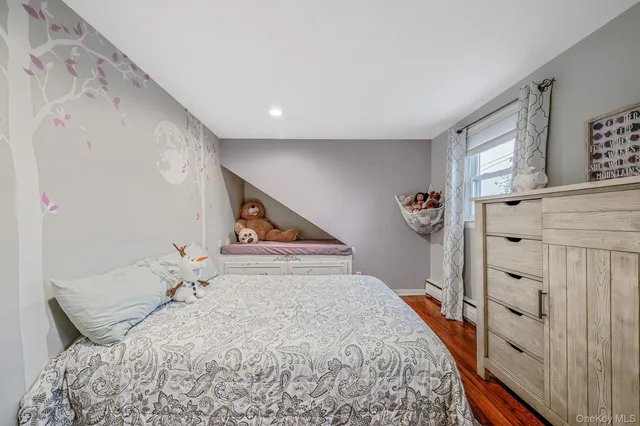 a view of a hallway with a window and wooden floor
