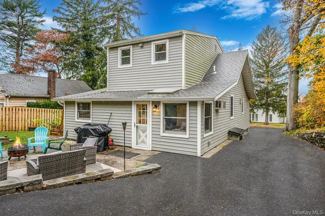 a view of a patio with couple of chairs and a fire pit