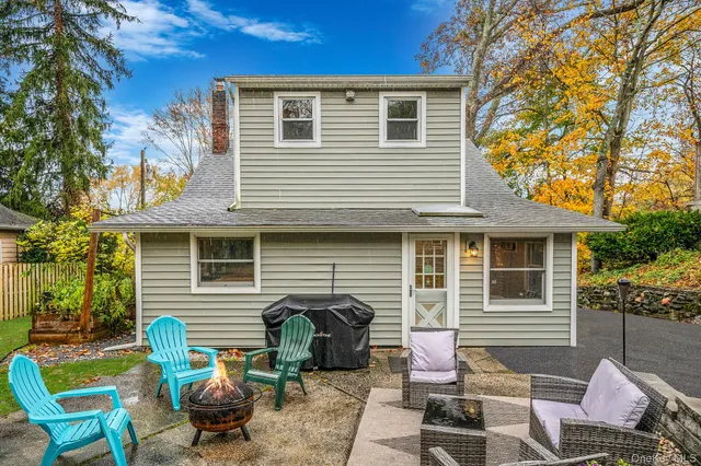 a view of a patio with couches chairs and a fire pit