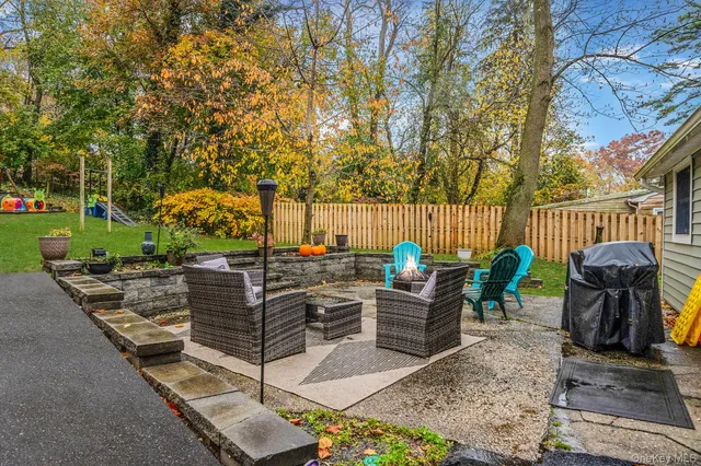 a front view of a house with a yard and a garden