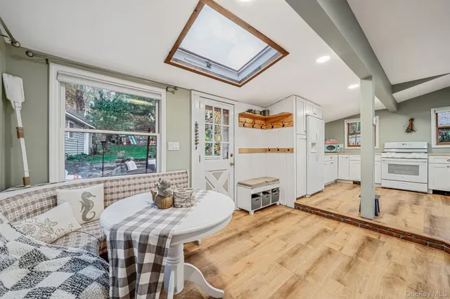 a room with stainless steel appliances furniture and a large window