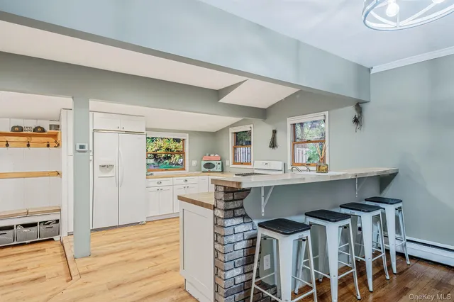 a kitchen with a table chairs refrigerator and cabinets