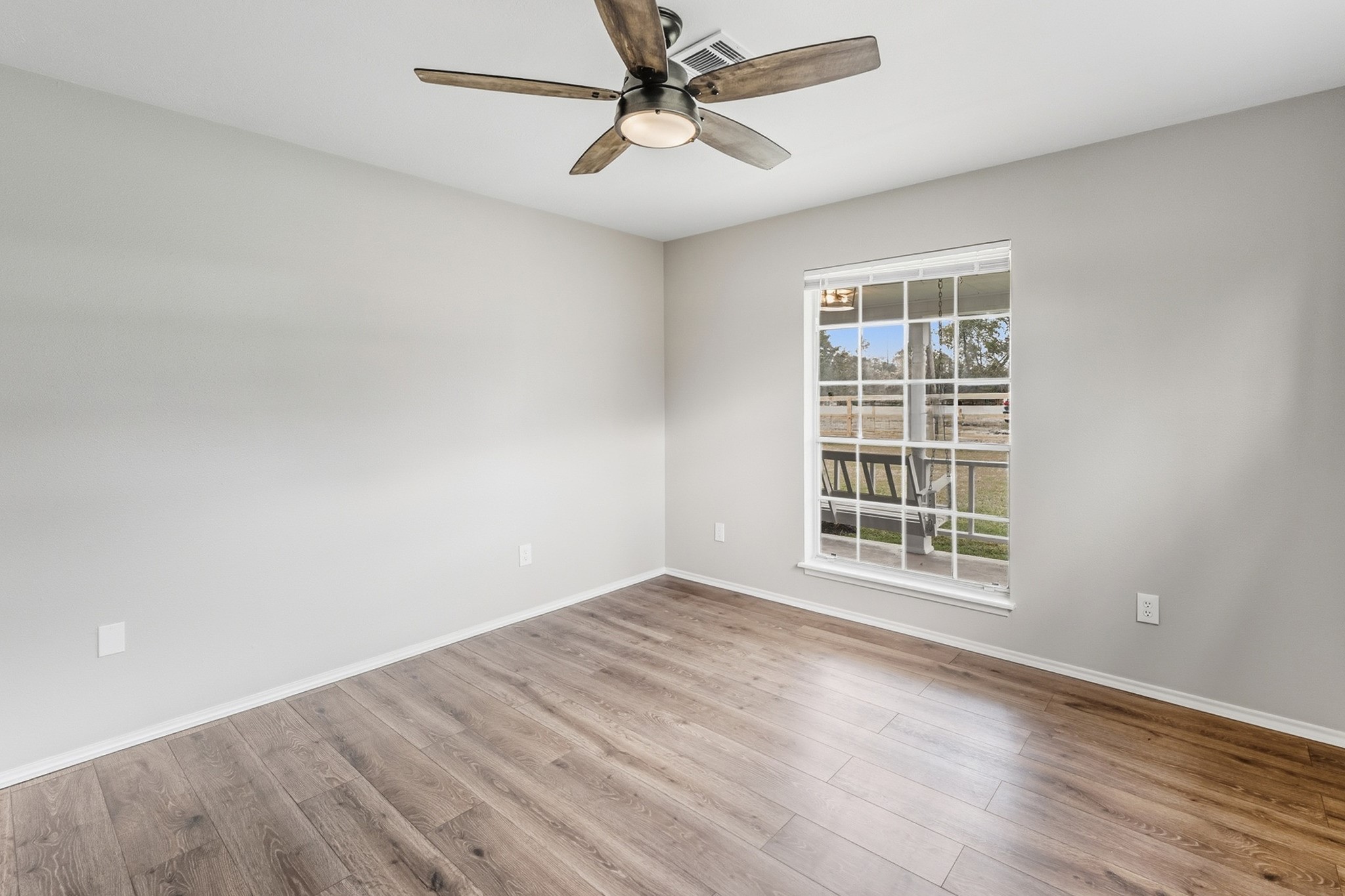 791 Farm To Market 1617 Trinity, TX 75862 - Photo 33 of 50 an empty room with wooden floor fan and windows
