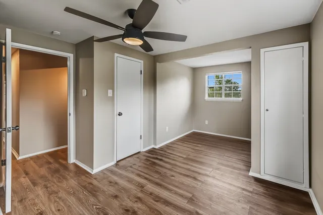 wooden floor in an empty room with a window