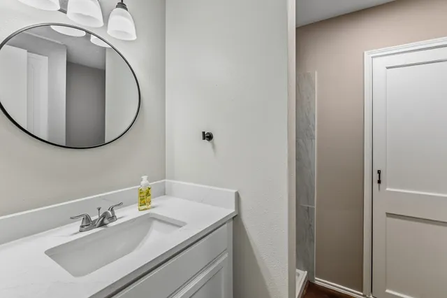 a bathroom with a sink and mirror