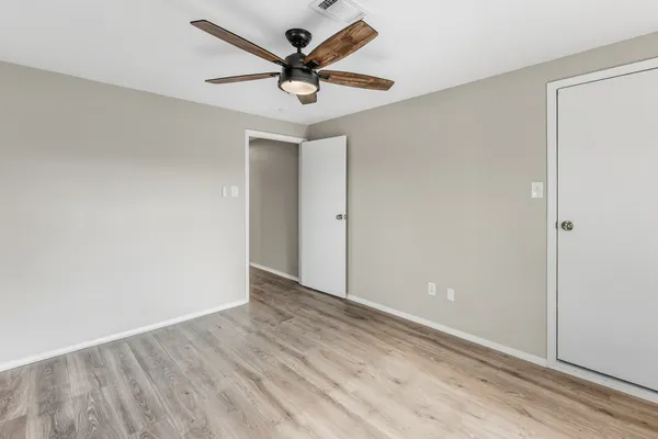 a view of a livingroom with a ceiling fan and wooden floor