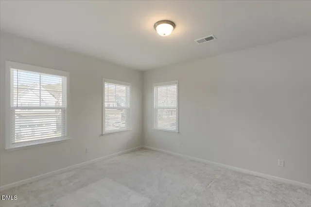 an empty room with closet area
