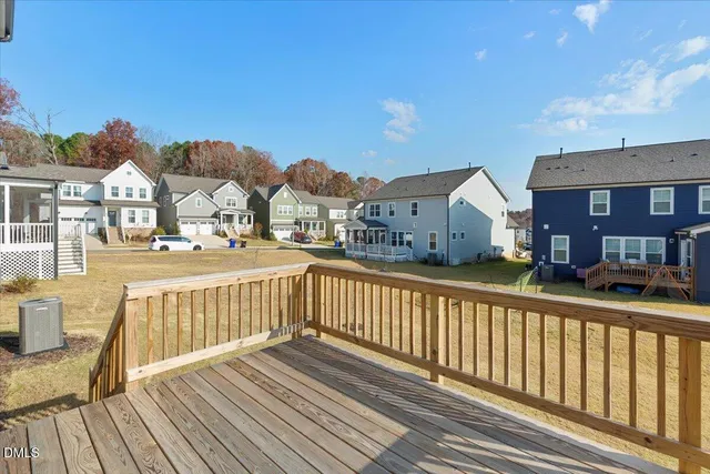 a view of swimming pool with seating area and trees in the background