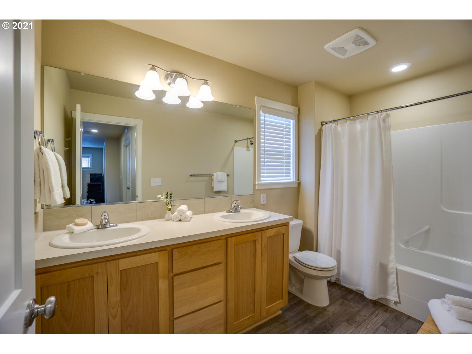 4639 North Noble Loop Ridgefield, WA 98642 - Photo 22 of 32 a bathroom with a double vanity sink toilet and a mirror