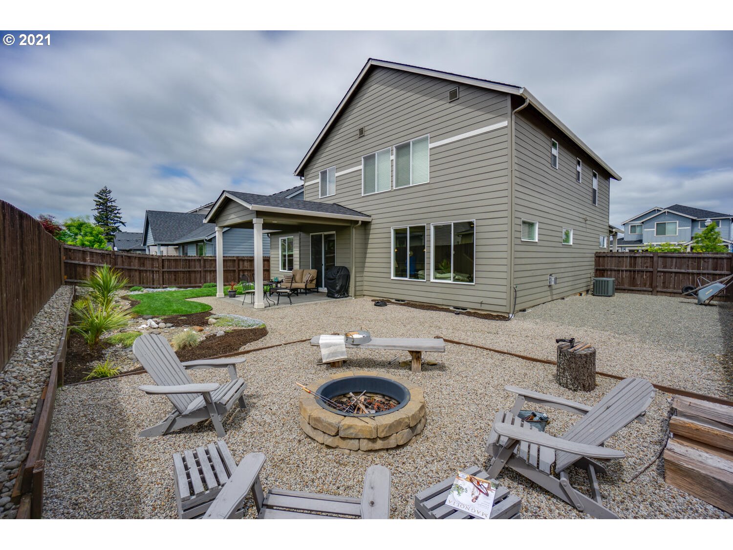 4639 North Noble Loop Ridgefield, WA 98642 - Photo 29 of 32 a view of house with backyard outdoor seating and trees in the background