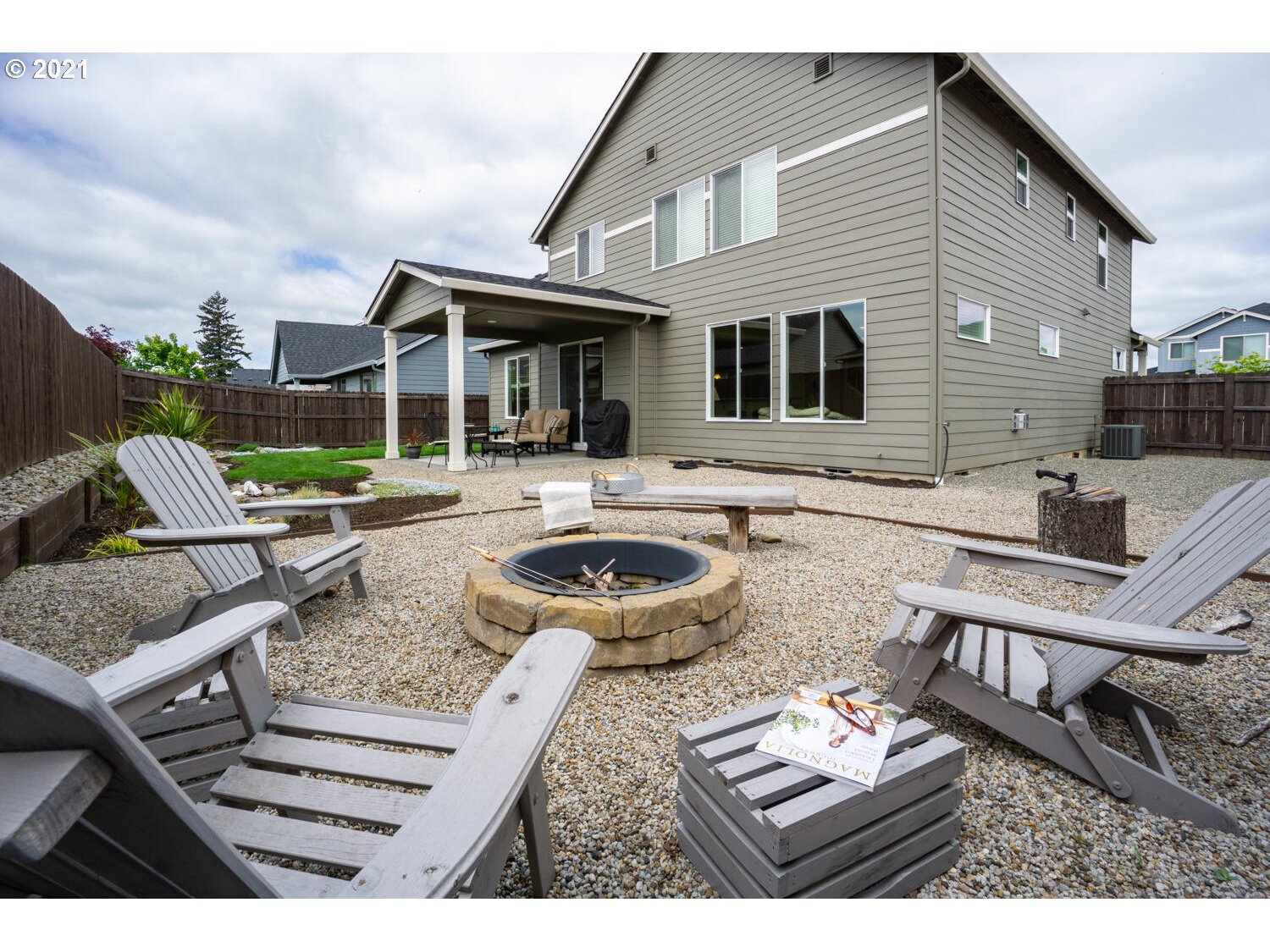 4639 North Noble Loop Ridgefield, WA 98642 - Photo 30 of 32 a view of a patio with couches table and chairs with wooden fence