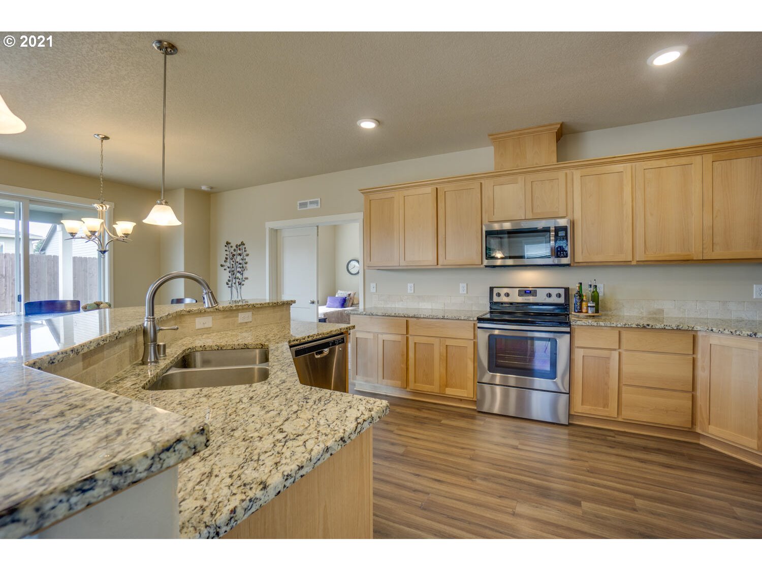 4639 North Noble Loop Ridgefield, WA 98642 - Photo 9 of 32 a kitchen with kitchen island granite countertop a sink counter top space appliances and cabinets