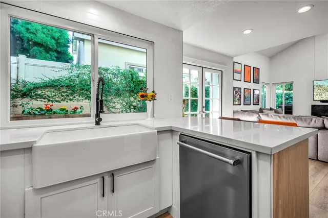 a kitchen with a sink and large window