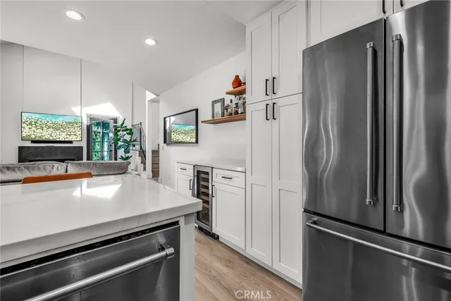 a kitchen with stainless steel appliances a refrigerator and a stove