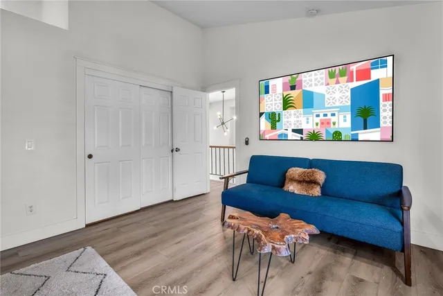 a living room with furniture and a painting on the wall