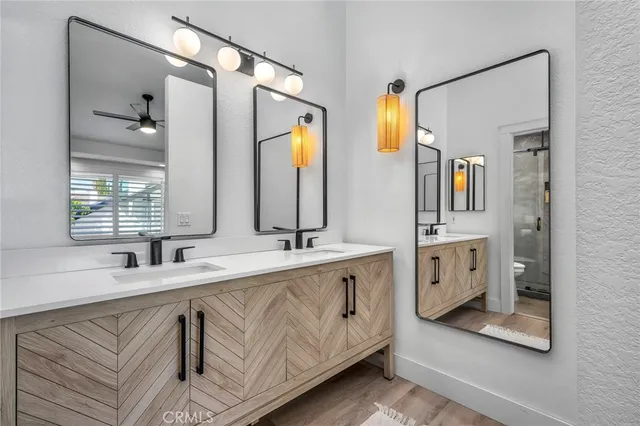 a bathroom with double vanity and a mirror