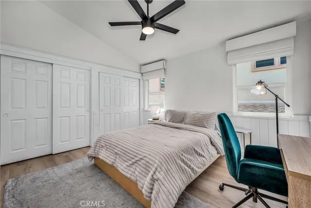 a bedroom with a bed a desk and chair