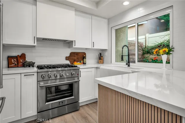 a kitchen with stainless steel appliances granite countertop a stove and a sink