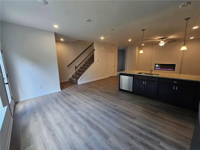 a view of a room with wooden floor