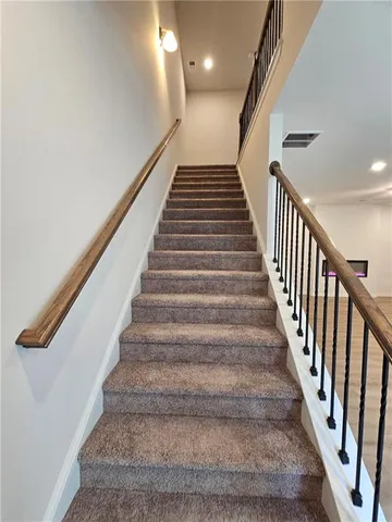 a view of a room with wooden floor