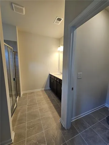 a bathroom with a shower and a sink