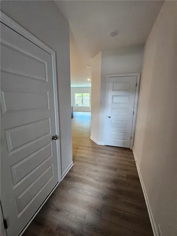 a view of an empty room and wooden floor