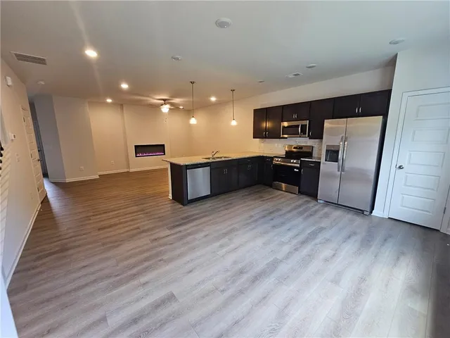a view of a kitchen with a sink and a refrigerator