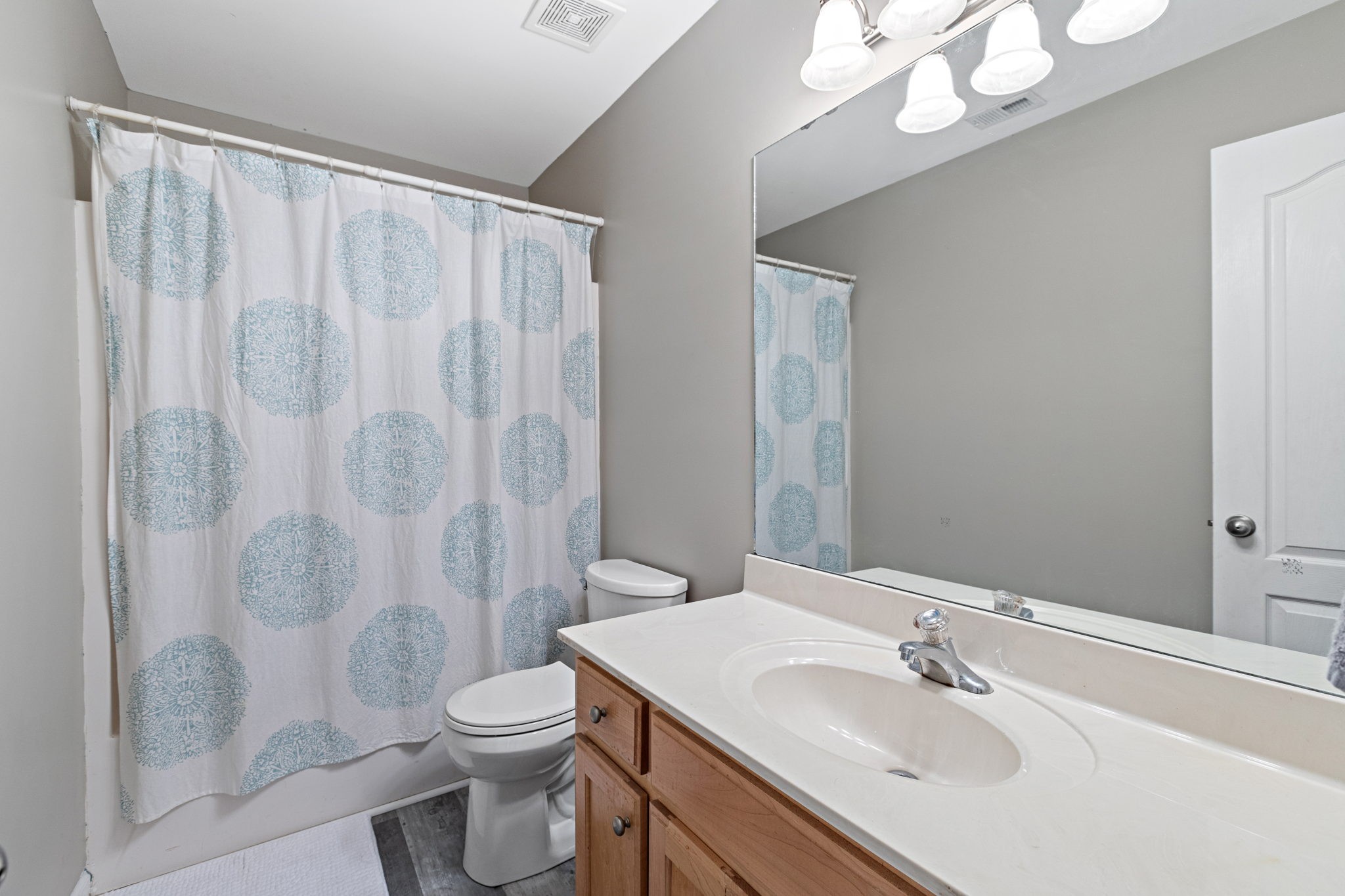 944 Pebble Beach Circle Mount Juliet, TN 37122 - Photo 11 of 19 a bathroom with a sink a toilet and shower curtain