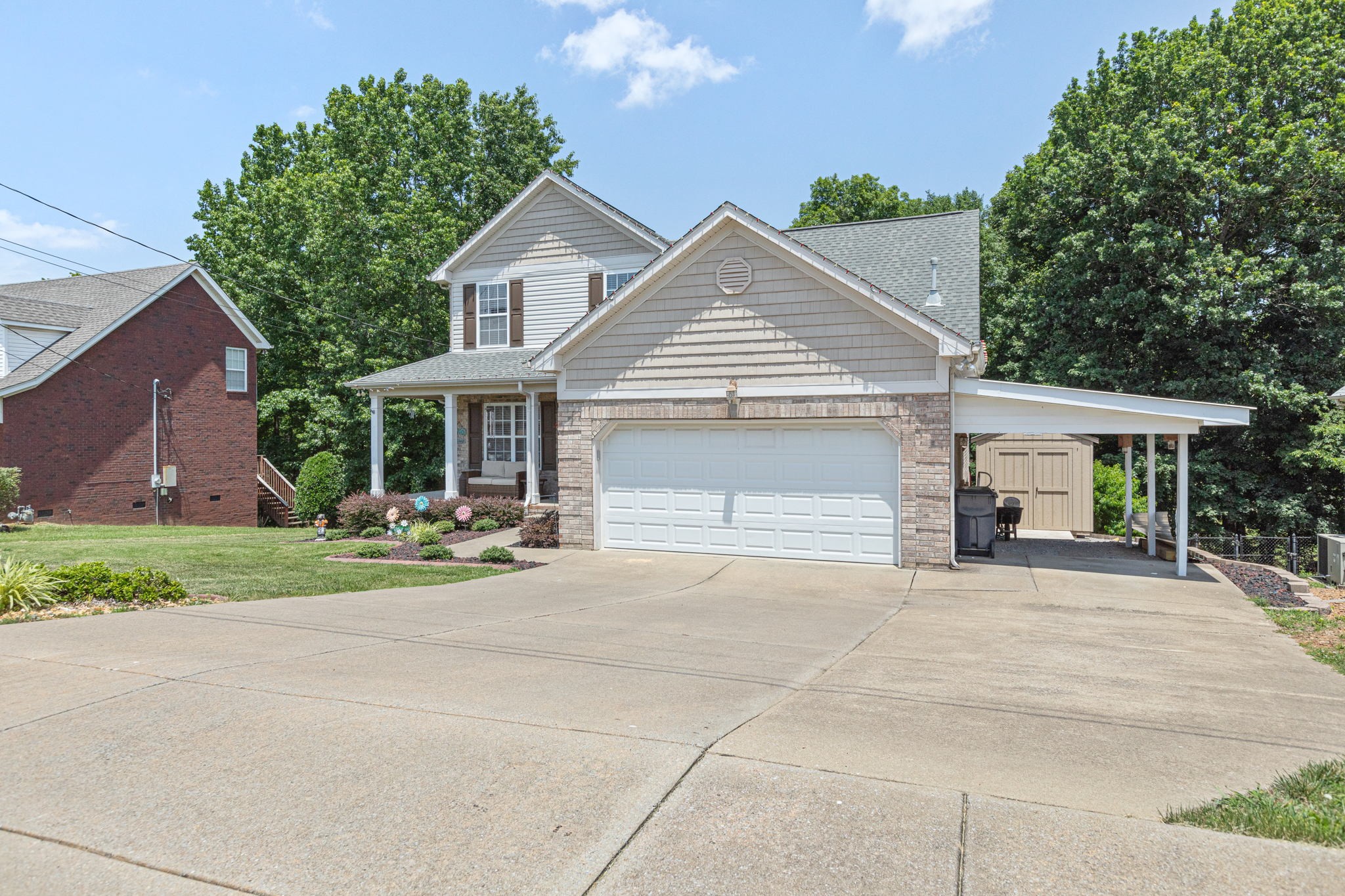 944 Pebble Beach Circle Mount Juliet, TN 37122 - Photo 2 of 19 a front view of a house with a garden and trees