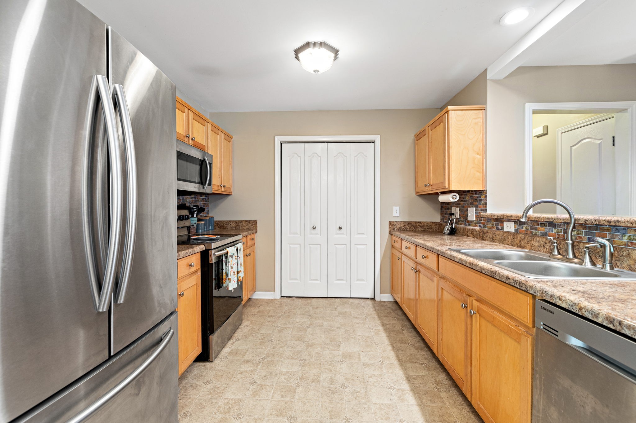 944 Pebble Beach Circle Mount Juliet, TN 37122 - Photo 7 of 19 a kitchen with a refrigerator sink and stove