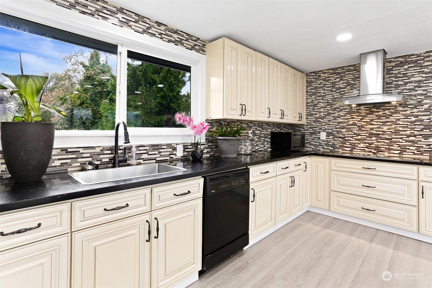 2124 High Avenue Northeast Renton, WA 98056 - Photo 5 of 37 a kitchen with stainless steel appliances white cabinets a stove a sink and a potted plant