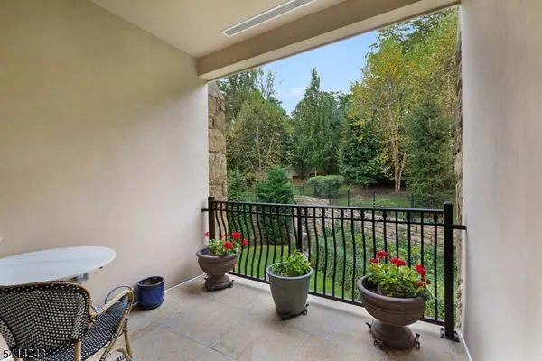 a view of a chair and table in the balcony